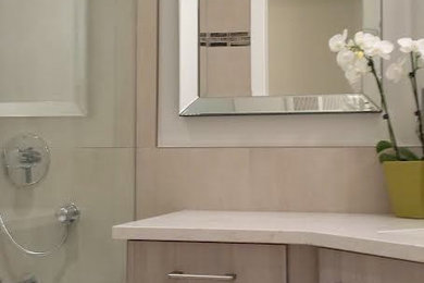 Example of a small transitional master gray tile and ceramic tile ceramic tile and brown floor bathroom design in Vancouver with flat-panel cabinets, light wood cabinets, a one-piece toilet, gray walls, an undermount sink, quartz countertops and white countertops