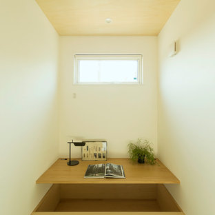 Inspiration for a small scandinavian home office in Other with white walls, tatami floors, a built-in desk and green floor.