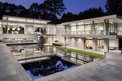 Large mid-century modern gray two-story stone exterior home photo