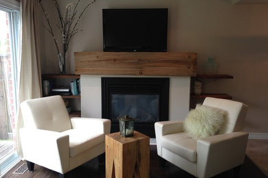 Trendy ceramic tile and beige floor living room photo in Toronto with beige walls, a standard fireplace, a concrete fireplace and a tv stand