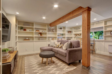Example of a mid-sized classic laminate floor family room library design in Seattle with white walls and a wall-mounted tv