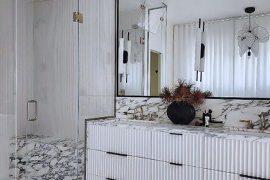 Example of a trendy double-sink bathroom design in Chicago with marble countertops and a built-in vanity