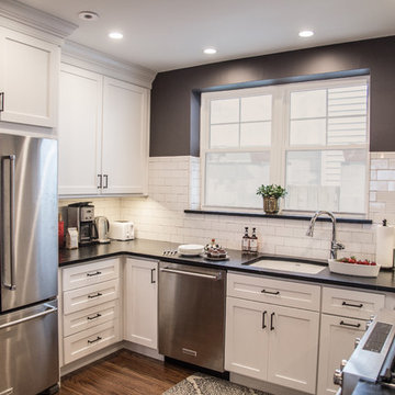Urban Loft Kitchen Remodel | White Shaker Cabinetry & Exposed Brick