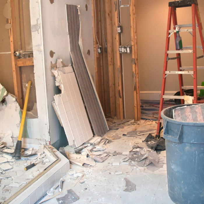 A bathroom mid-renovation with tools and materials scattered, illustrating the mess and risks of DIY remodeling.