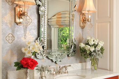 Example of a classic master bathroom design in Minneapolis with medium tone wood cabinets, marble countertops and blue walls