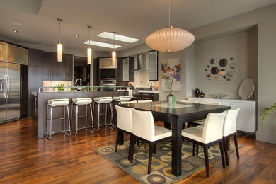 Inspiration for a mid-sized contemporary u-shaped medium tone wood floor eat-in kitchen remodel in Other with flat-panel cabinets, dark wood cabinets, quartz countertops, white backsplash, ceramic backsplash, stainless steel appliances and an island