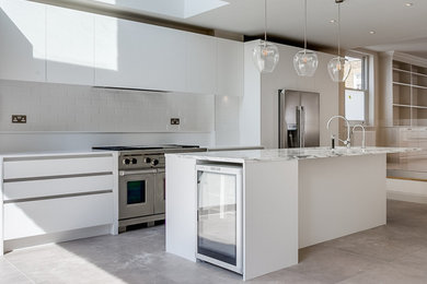 Design ideas for a large contemporary open plan kitchen in London with stainless steel appliances and an island.