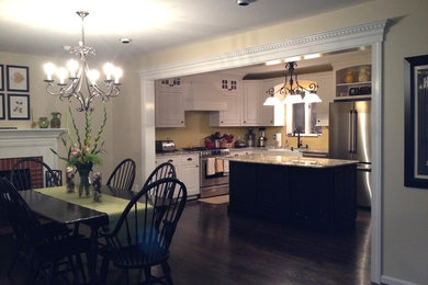Kitchen/dining room combo - large traditional dark wood floor kitchen/dining room combo idea in DC Metro with beige walls, a standard fireplace and a brick fireplace