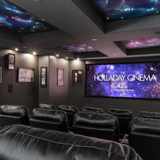 Home theater - large mediterranean open concept carpeted and gray floor home theater idea in Salt Lake City with black walls and a projector screen