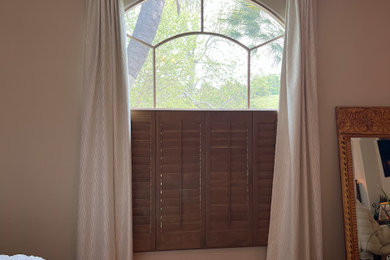 Bedroom - large traditional master light wood floor bedroom idea in Santa Barbara with beige walls