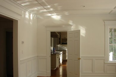 Enclosed dining room - mid-sized traditional enclosed dining room idea in New York with white walls