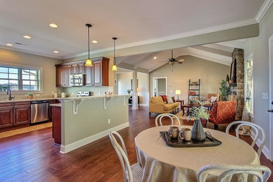 Mid-sized arts and crafts u-shaped dark wood floor eat-in kitchen photo in Other with a double-bowl sink, raised-panel cabinets, medium tone wood cabinets, granite countertops, stainless steel appliances and a peninsula