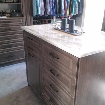 Beautiful Master Closet with island and unique jewelry cabinet
