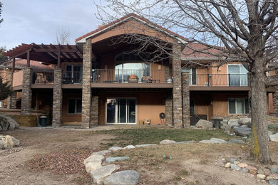 Inspiration for a huge contemporary backyard second story metal railing deck remodel in Other with a roof extension