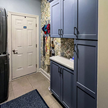 Laundry Room with Blue Painted Cabinetry and Sparkling White Quartz Countertops