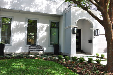 Large contemporary beige two-story stucco exterior home idea in Houston