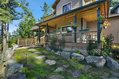 Example of a large beige two-story wood exterior home design in Seattle