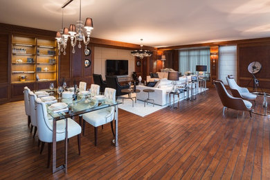 Inspiration for a large modern open concept dark wood floor living room remodel in Other with brown walls and a wall-mounted tv