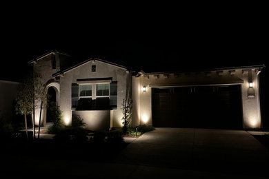 Example of a small tuscan beige one-story stucco house exterior design in Sacramento with a tile roof and a brown roof