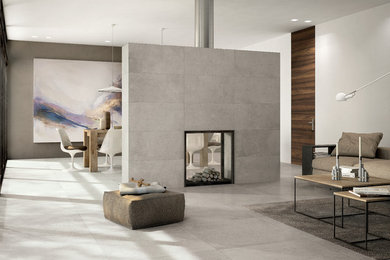 Modern living room in Denver with white walls, porcelain floors, a two-sided fireplace and a tile fireplace surround.