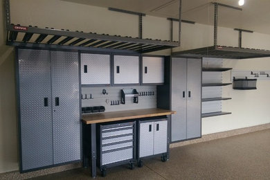 Inspiration for a mid-sized transitional attached two-car garage workshop remodel in Denver
