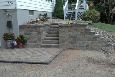Inspiration for a small contemporary side yard concrete paver patio remodel in Other