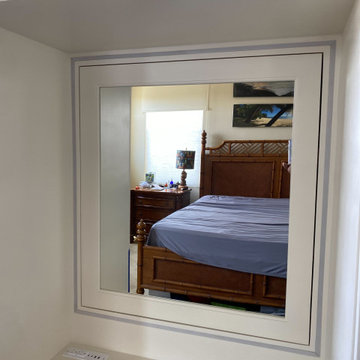 Mirrored Door with hidden storage and desk outlet for hair dryer and lit mirror