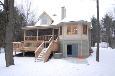 This is an example of a mid-sized traditional two-storey grey exterior in Other with vinyl siding.