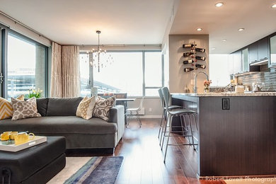 Inspiration for a small contemporary open concept medium tone wood floor living room remodel in Vancouver with gray walls