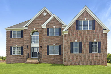 Large traditional red brick house exterior idea in New York