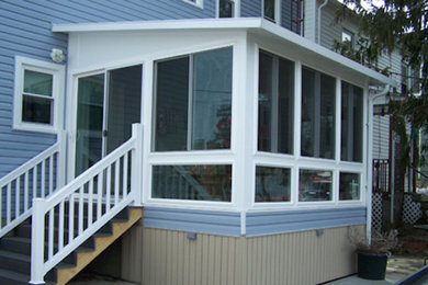Large elegant sunroom photo in Other