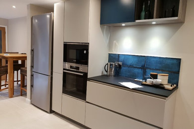 This is an example of a small modern kitchen in Kent.