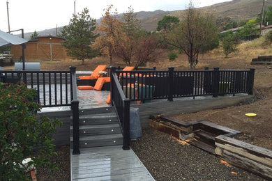 Example of a mid-sized mountain style backyard deck design in Other with no cover
