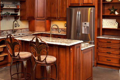 Inspiration for a timeless l-shaped kitchen remodel with a double-bowl sink, medium tone wood cabinets, granite countertops, stainless steel appliances and an island