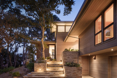 Inspiration for a large contemporary brown two-story wood house exterior remodel in San Francisco with a metal roof