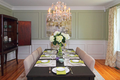 Photo of a large transitional separate dining room in Boston with green walls and medium hardwood floors.