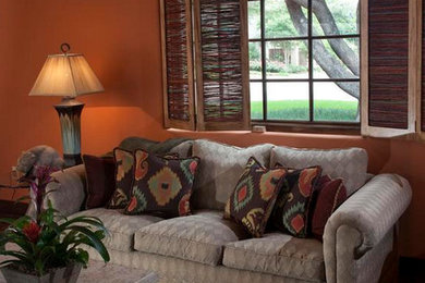 Example of a trendy living room design in Dallas with orange walls
