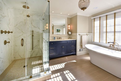 Inspiration for a large modern master stone tile and beige tile porcelain tile and beige floor bathroom remodel in DC Metro with recessed-panel cabinets, blue cabinets, a two-piece toilet, an undermount sink, marble countertops and white walls
