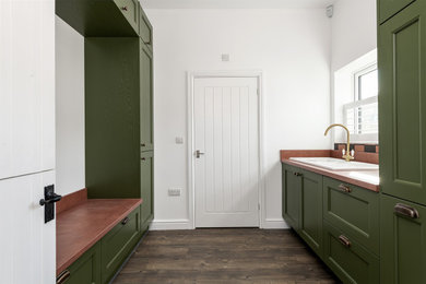 Photo of a large traditional utility room in Kent with shaker cabinets and green cabinets.