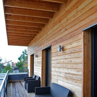 Photo of a medium sized rustic balcony in Marseille with a roof extension.