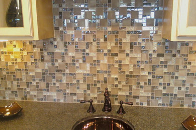 Inspiration for a modern kitchen remodel in DC Metro with an undermount sink, glass-front cabinets, light wood cabinets, beige backsplash and glass tile backsplash