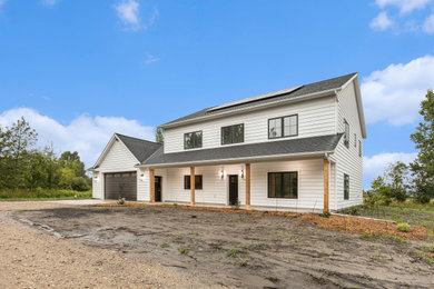 Inspiration for a farmhouse white house exterior remodel in Grand Rapids