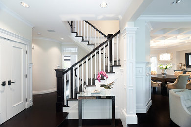Example of a classic wooden u-shaped staircase design in Vancouver