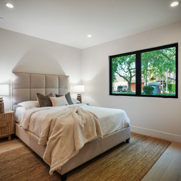 Guest Bedroom with Tall Upholstered Headboard and Sloped Ceiling