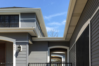 Inspiration for a large contemporary gray two-story vinyl exterior home remodel in Chicago