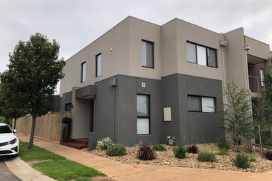Mid-sized trendy beige two-story brick exterior home photo in Melbourne with a metal roof
