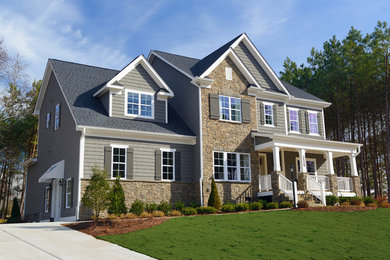 Example of a classic gray three-story mixed siding exterior home design in Raleigh