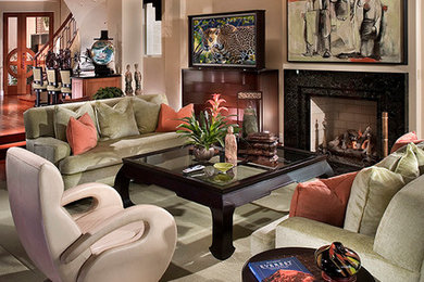 Family room - mid-sized traditional open concept dark wood floor family room idea in Orange County with beige walls, a standard fireplace and a concealed tv