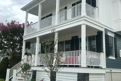 This is an example of a large traditional concrete paver front porch design in Philadelphia.