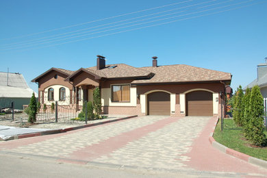 This is an example of a mid-sized modern home design in Other.